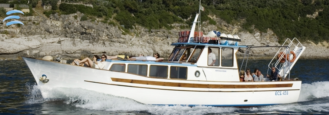 Passenger gozzo boat cruising along the coast