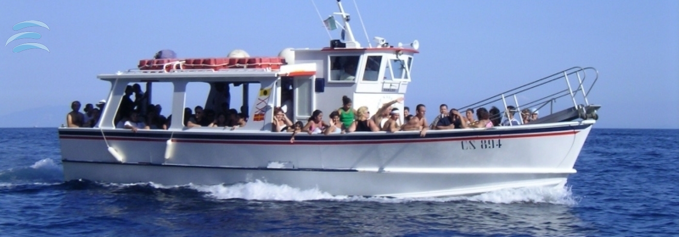 Passenger gozzo boat cruising along the coast