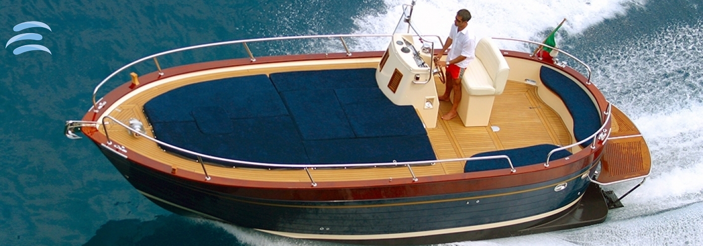 Small private boat cruising along the coast