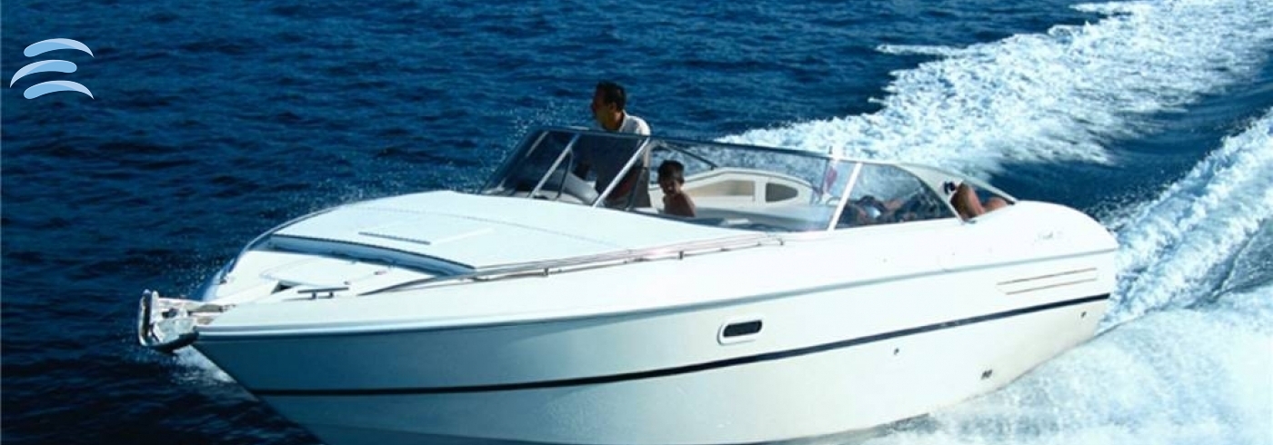 Small private boat cruising along the coast